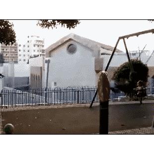 A dad hits his swinging son in the face with a ball.