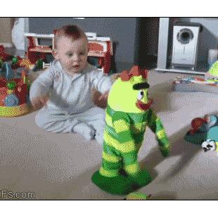 A baby has fun with a dancing toy.