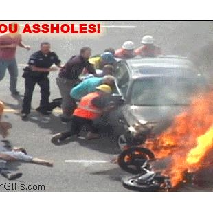 Pushed-under-burning-car-captioned