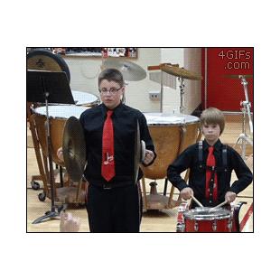 A band member tries to recover after dropping a cymbal