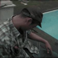 Friends prank a drunk guy passed out in a pool chair.