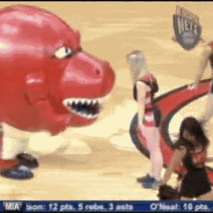 A mascot swallows a cheerleader