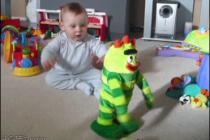 A baby has fun with a dancing toy.