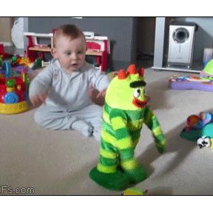 A baby has fun with a dancing toy.