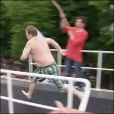A guy runs off a diving board and bellyflops