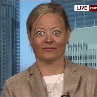 A woman's eyes are wide open during a TV interview.